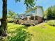 Charming backyard showcasing a well-maintained lawn, wooden fence, and verdant trees at 927 Dills Bluff Rd # 33, Charleston, SC 29412