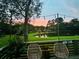 A scenic backyard view featuring a tranquil pond, mature trees and vibrant sunset at 927 Dills Bluff Rd # 33, Charleston, SC 29412