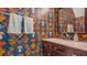 Half bath featuring mushroom themed wallpaper, a dark wood cabinet, and marble countertop at 947 E Estates Blvd # C, Charleston, SC 29414