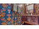 A powder room featuring vibrant wallpaper, a dark vanity, and modern sink and faucet fixtures at 947 E Estates Blvd # C, Charleston, SC 29414
