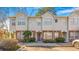 Exterior view of a townhome featuring neutral siding, brick accents, and neat landscaping in a multi-unit building at 947 E Estates Blvd # C, Charleston, SC 29414