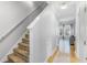 Bright hallway with carpeted stairs leading to the upstairs and an open view into a naturally lit living room at 947 E Estates Blvd # C, Charleston, SC 29414