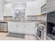 Bright kitchen featuring stainless steel appliances, white cabinetry, and grey countertops at 947 E Estates Blvd # C, Charleston, SC 29414