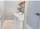 Functional laundry room with essential appliances and extra shelving for storage at 947 E Estates Blvd # C, Charleston, SC 29414