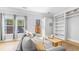 Inviting living room with backyard access and natural light showcases an open design and custom built-in shelving at 947 E Estates Blvd # C, Charleston, SC 29414