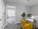 Office space with bright yellow accent chair, a desk with a computer, and view into another room at 947 E Estates Blvd # C, Charleston, SC 29414