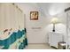Bathroom includes a cabinet, a lamp, a Dr. Seuss themed shower curtain, and a decorative piece of art at 1009 Seacrest Ln, Folly Beach, SC 29439
