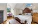Bedroom features a sloped ceiling, an accent window, a desk area, and a decorative wooden bedframe at 1009 Seacrest Ln, Folly Beach, SC 29439