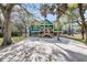Charming raised beach home with a spacious driveway, mature trees, and a welcoming front porch at 1009 Seacrest Ln, Folly Beach, SC 29439