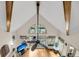 Open-concept living room with a large accent window, hardwood floors, and a cozy fireplace with mounted television at 1009 Seacrest Ln, Folly Beach, SC 29439