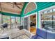 Outdoor patio features a grill, deck chairs, and a peek into the interior of the home through sliding glass doors at 1009 Seacrest Ln, Folly Beach, SC 29439
