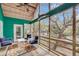 Outdoor patio boasts a ceiling fan, and patio chairs with a view into the greenery of the backyard at 1009 Seacrest Ln, Folly Beach, SC 29439