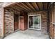 Brick back porch features concrete flooring, a door and a sliding glass door at 102 Brush Blvd, Goose Creek, SC 29445