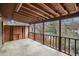 Spacious screened-in back porch with wood flooring and railing overlooking trees and river at 102 Brush Blvd, Goose Creek, SC 29445