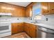 Cozy kitchen with wood cabinets, white appliances, and marble-look countertops at 102 Brush Blvd, Goose Creek, SC 29445