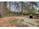 Backyard with mature trees, wooden fence, air conditioning unit, and a built-in grill at 103 York Pl, Goose Creek, SC 29445