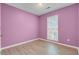 Cozy bedroom with lavender painted walls, hardwood floors, a window, and plenty of natural light at 103 York Pl, Goose Creek, SC 29445