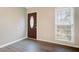 Entryway with a dark wood door, modern gray floors, and natural light from a window at 103 York Pl, Goose Creek, SC 29445