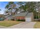 Cozy brick home with red shutters, gray roof, and attached garage on a tree-lined street at 103 York Pl, Goose Creek, SC 29445