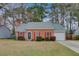 Charming brick home with red shutters, well-manicured lawn, and attached garage at 103 York Pl, Goose Creek, SC 29445