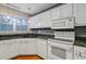 Bright kitchen with white appliances, updated cabinets and countertops features lots of natural light at 103 York Pl, Goose Creek, SC 29445