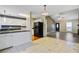Open kitchen/living room with black refrigerator, white cabinets, and lovely floors offers a great floorplan at 103 York Pl, Goose Creek, SC 29445