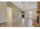 Bright living room with gray floors, a fireplace, and a modern ceiling fan at 103 York Pl, Goose Creek, SC 29445