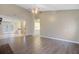 Open-concept living room with gray floors, lots of light, and views into kitchen and laundry at 103 York Pl, Goose Creek, SC 29445