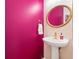 Bathroom features a decorative wicker-trimmed mirror and vibrant pink walls at 104 Chemistry Cir, Ladson, SC 29456