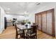 Open dining space features a view to the modern kitchen and contemporary lighting at 104 Chemistry Cir, Ladson, SC 29456