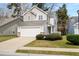 Charming two-story home featuring stone accents, a two-car garage, and manicured landscaping at 104 Chemistry Cir, Ladson, SC 29456