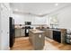 Well-lit kitchen with stainless steel appliances and an island, offering ample counter space at 104 Chemistry Cir, Ladson, SC 29456