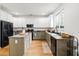 Well-lit kitchen with stainless steel appliances, white cabinets and an island with lots of counter space at 104 Chemistry Cir, Ladson, SC 29456