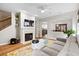 Cozy living area with a fireplace, modern ceiling fan and view to the adjacent dining area at 104 Chemistry Cir, Ladson, SC 29456