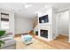 Bright living room with a fireplace, modern ceiling fan and a view to the staircase at 104 Chemistry Cir, Ladson, SC 29456