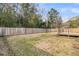 Large lot backyard with a wood perimeter fence and rear deck at 105 Gourdin St, Saint Stephen, SC 29479
