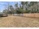 Large fenced-in backyard offering ample space and privacy, backing up to a wooded area at 105 Gourdin St, Saint Stephen, SC 29479