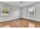 Empty bedroom with hardwood floors and two windows bringing in natural light at 105 Gourdin St, Saint Stephen, SC 29479