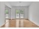 Sun-filled bedroom with hardwood floors, mirrored closet, and french doors to the backyard at 105 Gourdin St, Saint Stephen, SC 29479