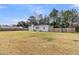 Single story home with large lot, long driveway, and perimeter fence at 105 Gourdin St, Saint Stephen, SC 29479