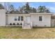 Charming single-story home with a freshly painted facade and well-manicured landscaping at 105 Gourdin St, Saint Stephen, SC 29479