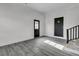 Bright living room featuring gray wood floors and updated white brick and fresh neutral paint at 105 Gourdin St, Saint Stephen, SC 29479