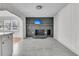 Bright living room featuring a painted brick fireplace, mantle, and television above at 105 Gourdin St, Saint Stephen, SC 29479