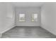 Bright room with two windows, gray floors, white walls, and white brick accent at 105 Gourdin St, Saint Stephen, SC 29479