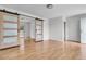 Bright living room with modern sliding barn doors and wood floors offers an open concept feel at 105 Gourdin St, Saint Stephen, SC 29479