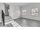 Living room with hardwood floors, natural light, and view into the kitchen at 105 Gourdin St, Saint Stephen, SC 29479