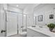 Bright bathroom boasts a white vanity with a sink, vanity mirror and a modern glass shower at 107 Cotton Blossom Way, Summerville, SC 29485