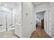 Bright bathroom boasts tiled floors, a modern vanity, and a glass-enclosed shower adjacent to entry to another room at 107 Cotton Blossom Way, Summerville, SC 29485