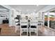 Dining area adjacent to kitchen with dark-top table and chairs, and sliding glass doors at 107 Cotton Blossom Way, Summerville, SC 29485