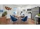 Bright dining area with wood table, blue chairs, and modern stainless steel appliances at 107 Cotton Blossom Way, Summerville, SC 29485